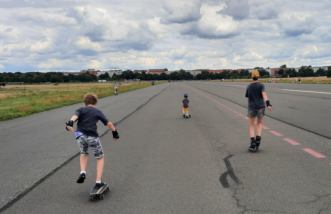 A woman with two children rollerskating